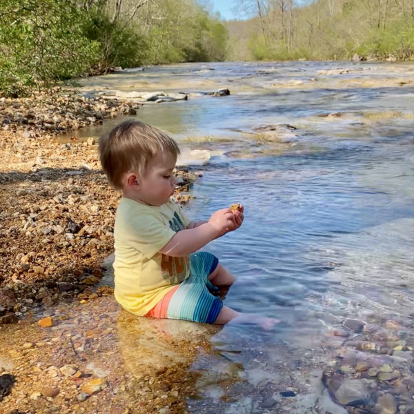 Baby sitting beside the creek